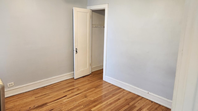 unfurnished bedroom with light hardwood / wood-style floors and a closet