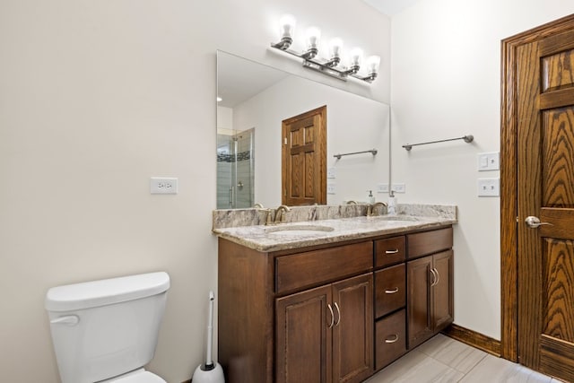 bathroom with tile patterned floors, vanity, toilet, and a shower with door