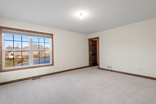 empty room featuring light colored carpet