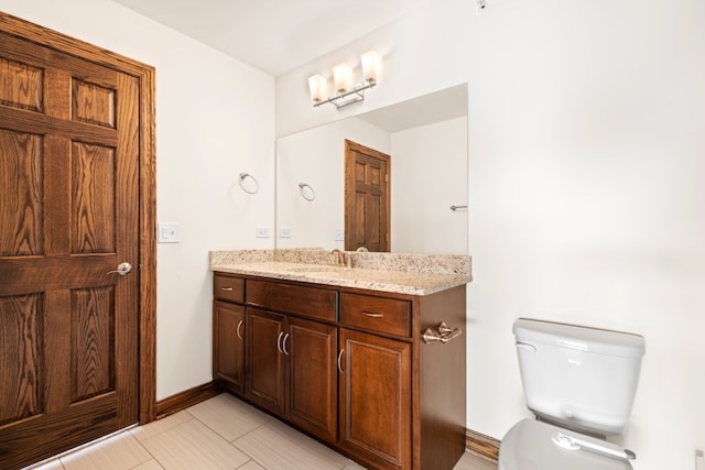 bathroom featuring tile patterned floors, vanity, and toilet