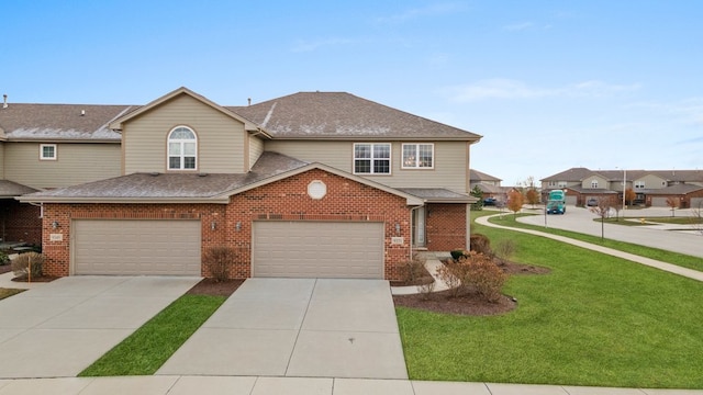 view of front property featuring a front lawn and a garage