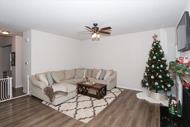 living room featuring dark hardwood / wood-style flooring and ceiling fan