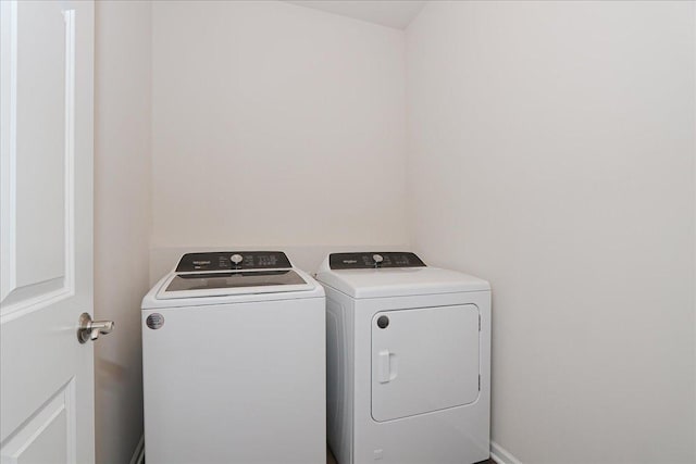 clothes washing area featuring washer and clothes dryer