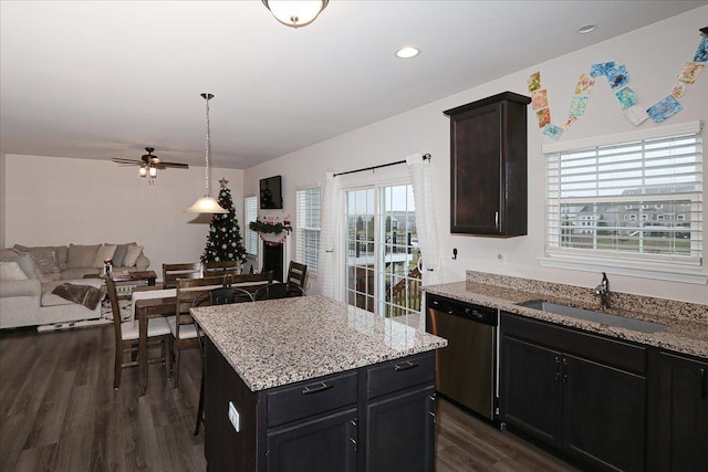 kitchen with sink, dark hardwood / wood-style floors, a center island, and dishwasher