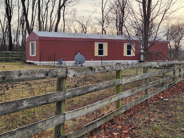 property exterior at dusk featuring an outdoor structure