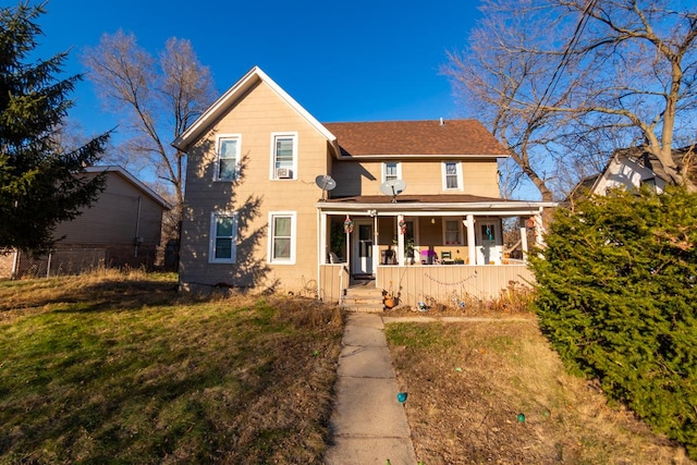 view of front of property with covered porch and a front lawn