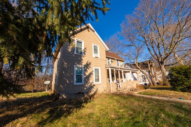 exterior space with covered porch and a yard