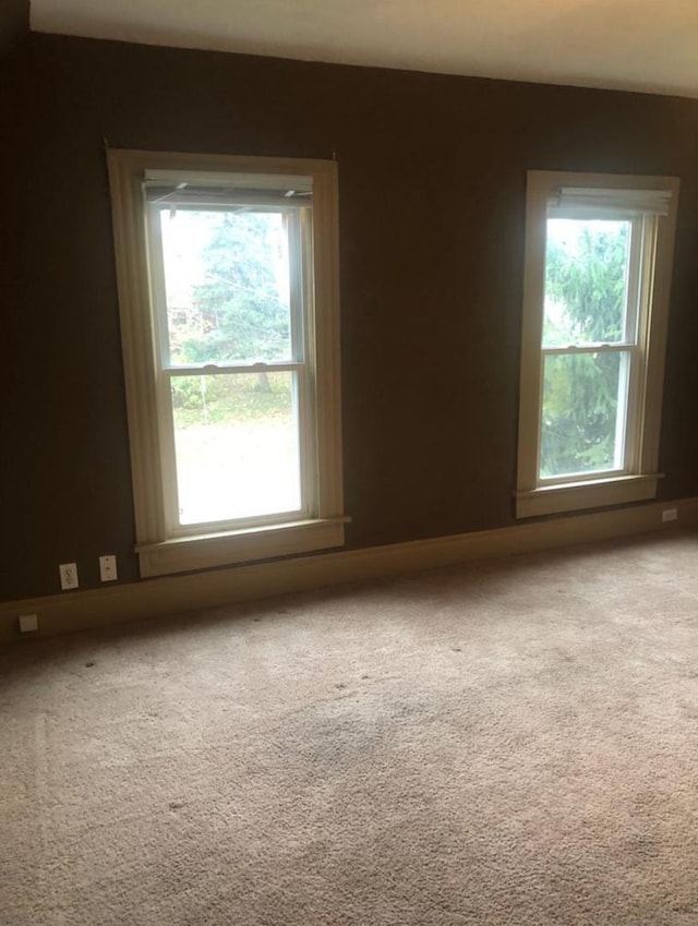 carpeted spare room featuring a wealth of natural light