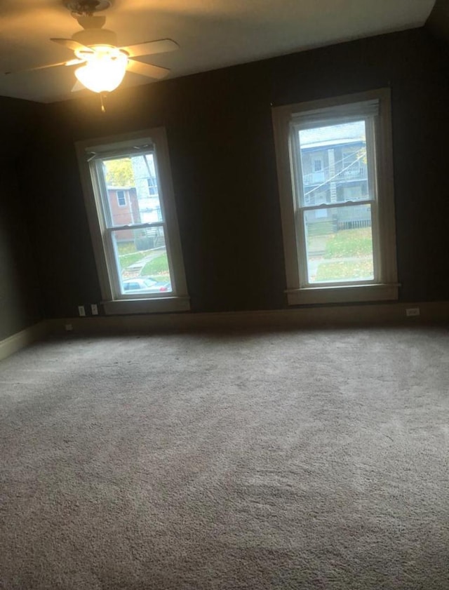 spare room with carpet flooring and ceiling fan