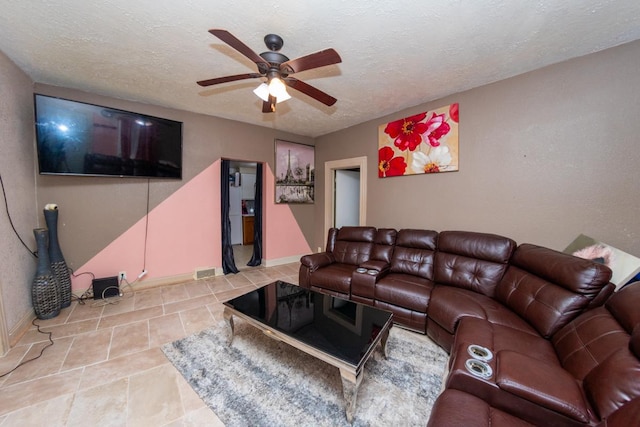 tiled living room featuring ceiling fan and a textured ceiling