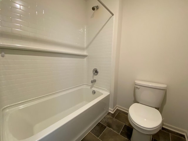 bathroom featuring tile patterned flooring, toilet, and tiled shower / bath