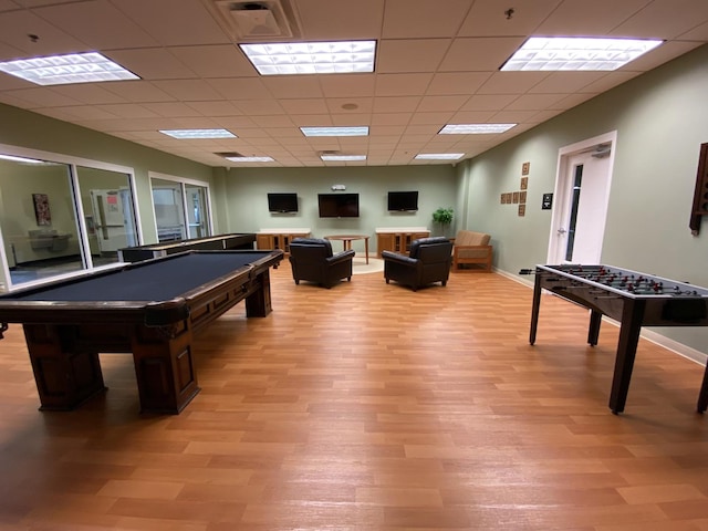 playroom featuring light wood-type flooring, a paneled ceiling, and billiards