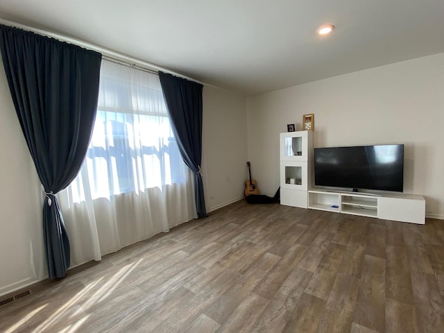 unfurnished living room with hardwood / wood-style floors