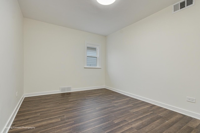 unfurnished room with dark hardwood / wood-style flooring