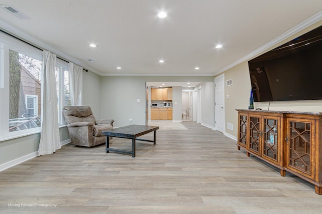 sitting room featuring light hardwood / wood-style floors and crown molding