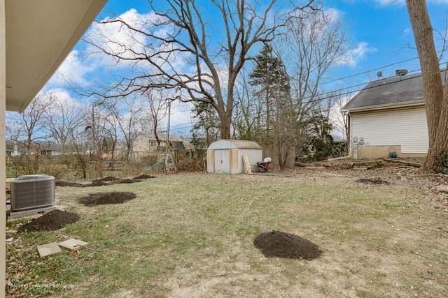 view of yard with central AC and a shed