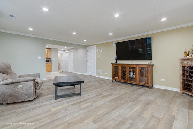 living room with light hardwood / wood-style flooring and ornamental molding