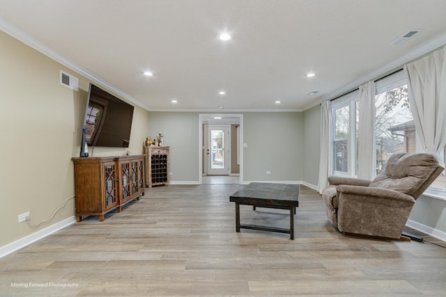 living room with light hardwood / wood-style flooring and ornamental molding