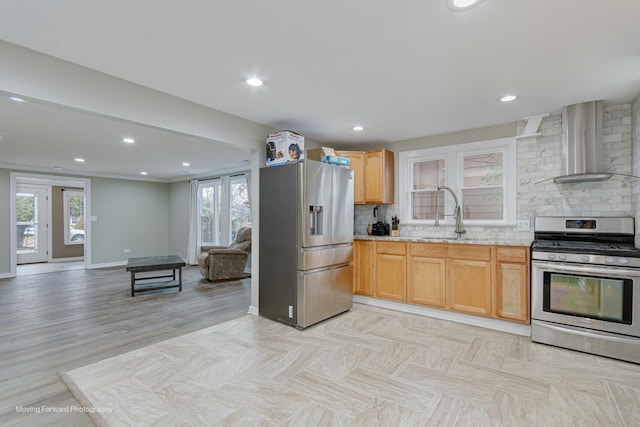 kitchen featuring sink, wall chimney exhaust hood, light wood-type flooring, appliances with stainless steel finishes, and tasteful backsplash