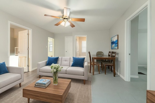 living room with hardwood / wood-style flooring and ceiling fan