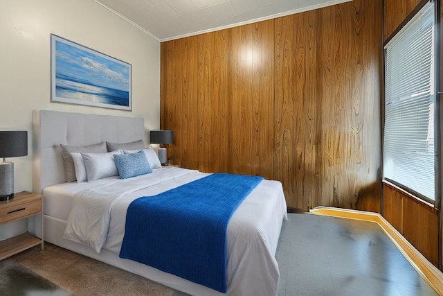 bedroom featuring crown molding, multiple windows, and wooden walls