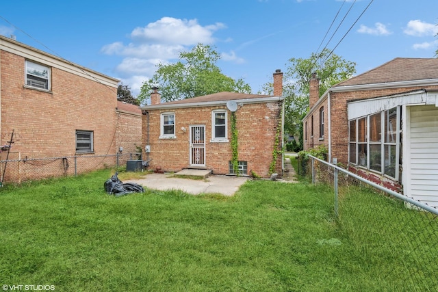 rear view of property with a lawn