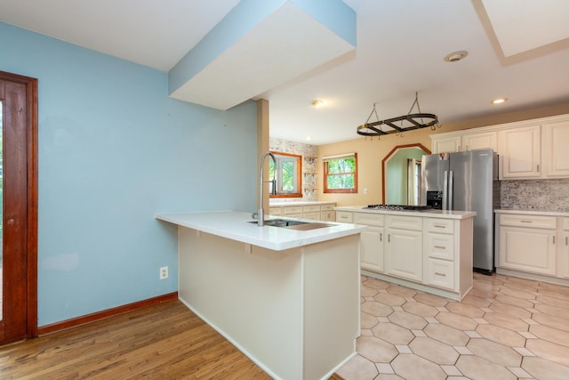 kitchen featuring appliances with stainless steel finishes, sink, white cabinets, and a breakfast bar