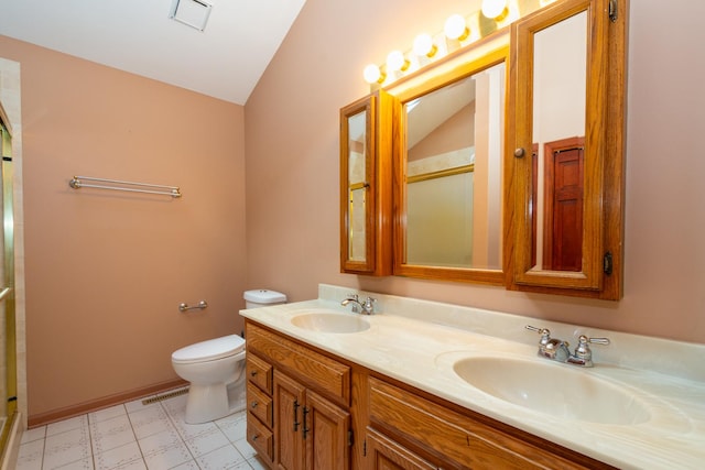 bathroom featuring vanity, lofted ceiling, walk in shower, and toilet