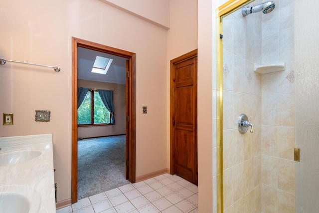 bathroom with vanity, a skylight, and a shower with shower door