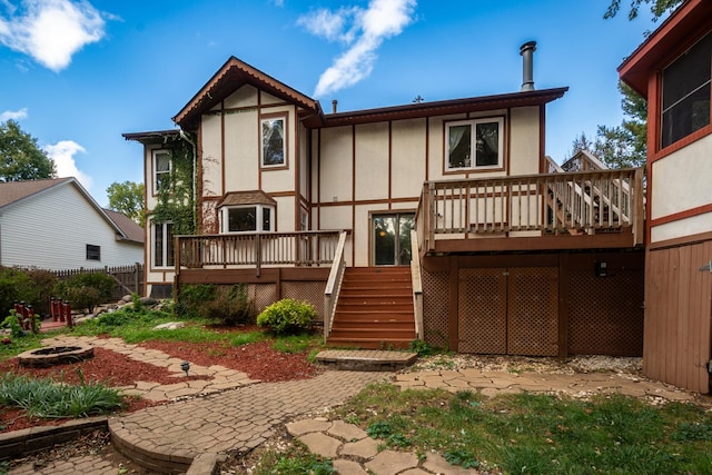 back of property with a wooden deck