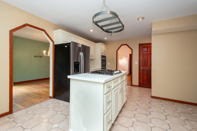 kitchen with stainless steel appliances, a center island, and light tile patterned floors