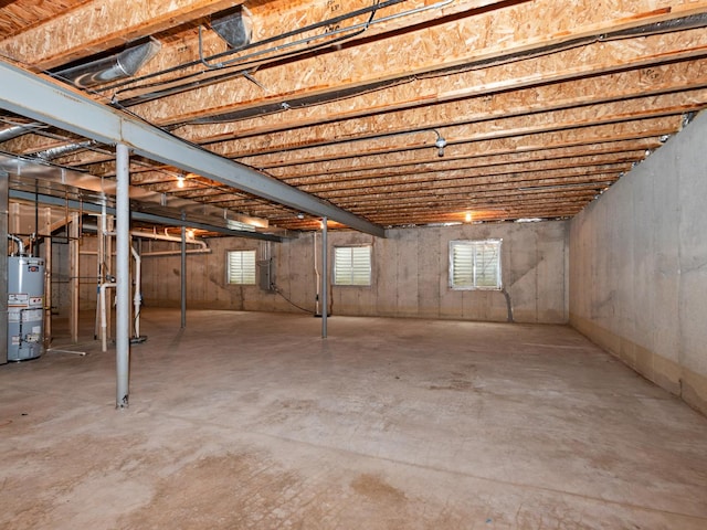 basement with electric panel and water heater