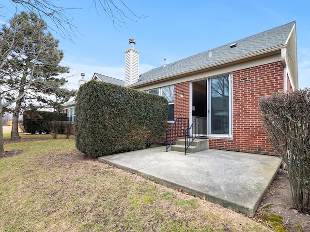 rear view of house featuring a yard and a patio