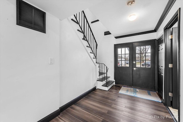 foyer entrance with french doors, dark hardwood / wood-style flooring, and ornamental molding