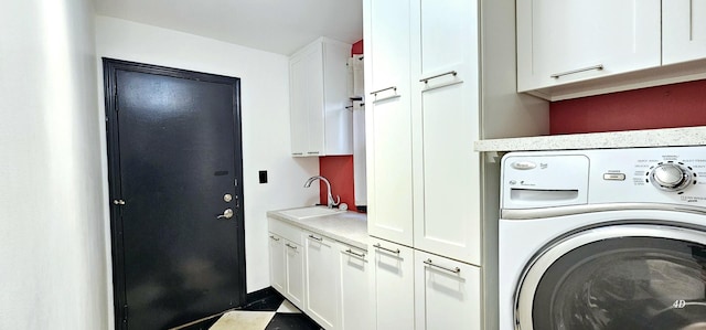 laundry room featuring cabinets, washer / clothes dryer, and sink