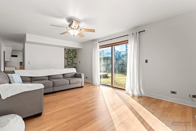 living room featuring ceiling fan and light wood-type flooring