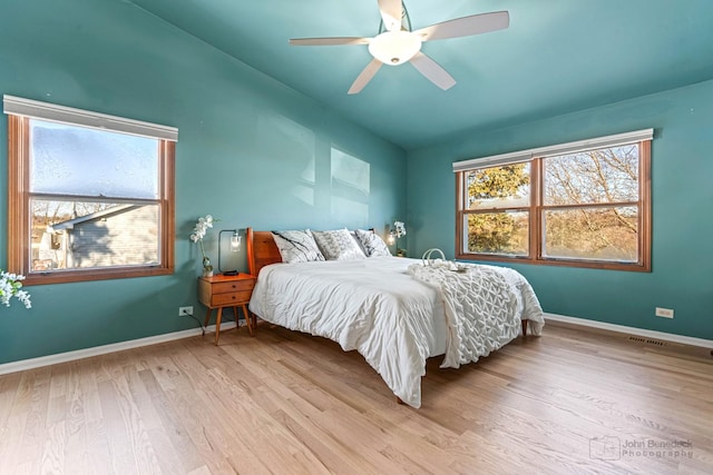 bedroom featuring lofted ceiling, ceiling fan, and light wood-type flooring