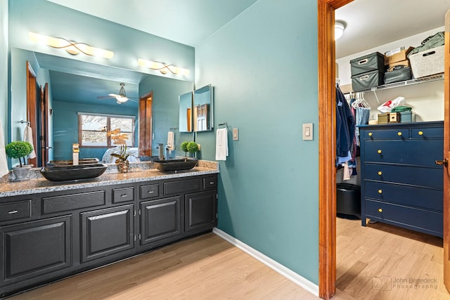 bathroom featuring ceiling fan, vanity, and hardwood / wood-style floors