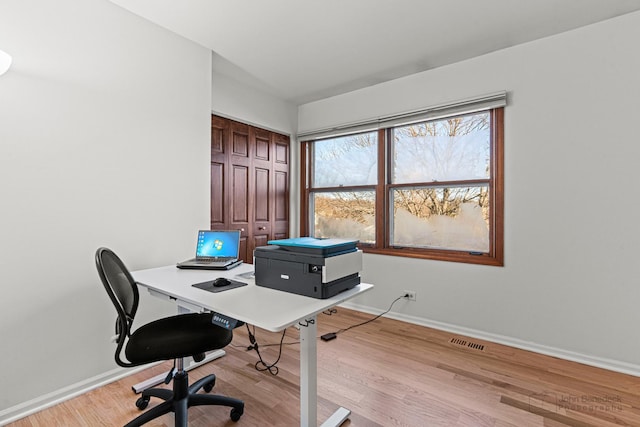 office space with light hardwood / wood-style floors