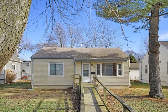 bungalow-style house with a front lawn