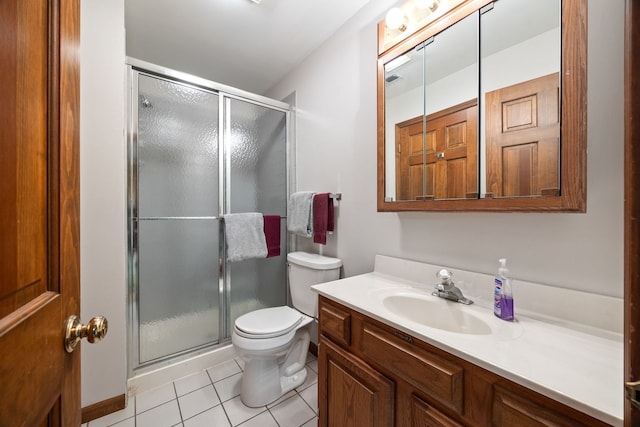 full bathroom featuring a stall shower, vanity, toilet, and tile patterned floors