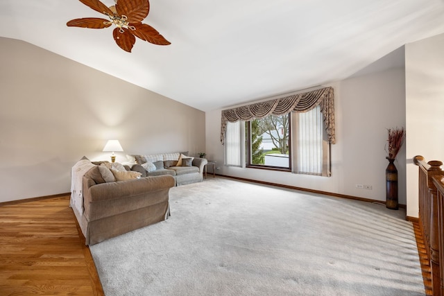 living room with baseboards, vaulted ceiling, and a ceiling fan