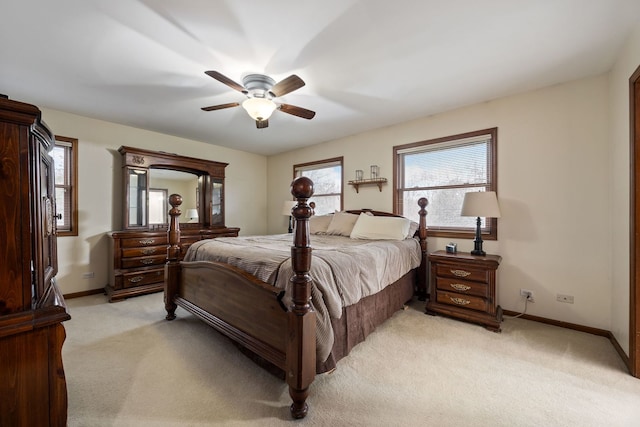 bedroom featuring a ceiling fan, light colored carpet, and baseboards