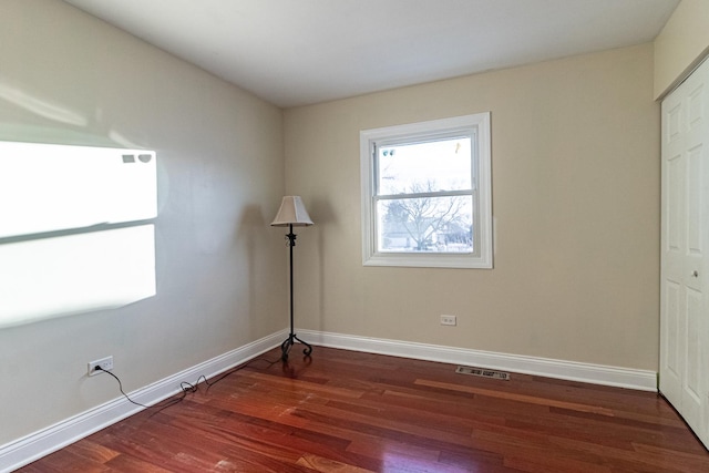 unfurnished room featuring dark hardwood / wood-style floors