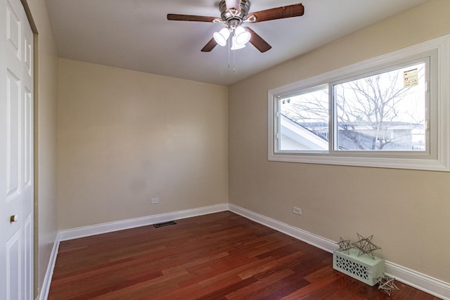 unfurnished room with ceiling fan and dark hardwood / wood-style flooring