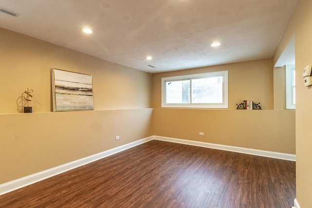 empty room with dark wood-type flooring