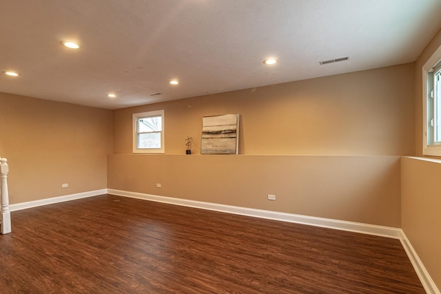 spare room featuring dark wood-type flooring