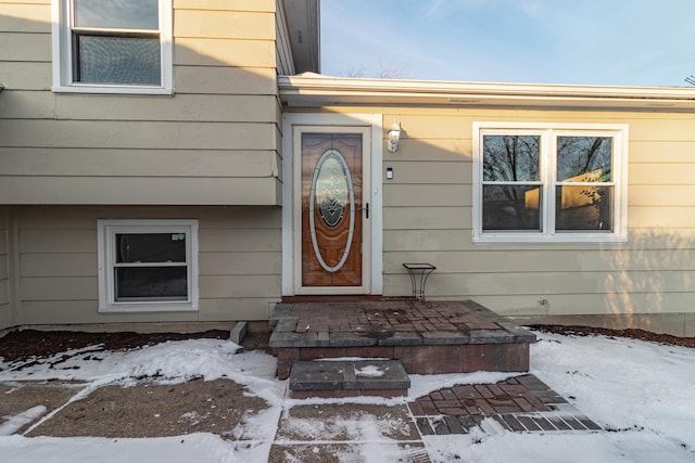 view of snow covered property entrance