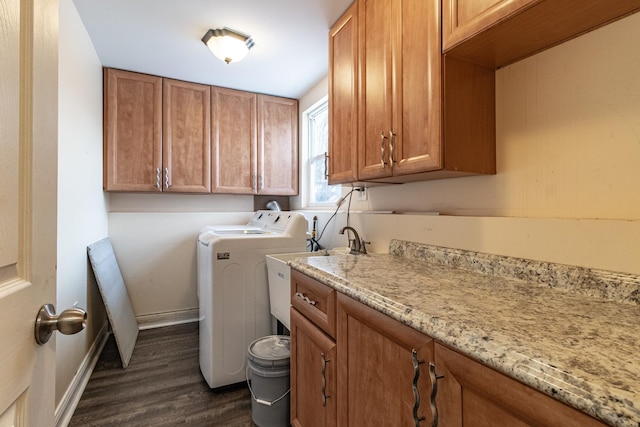 laundry room featuring cabinets, dark wood-type flooring, and washing machine and clothes dryer