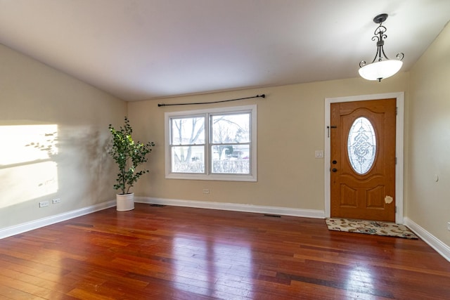 entryway with dark wood-type flooring and lofted ceiling